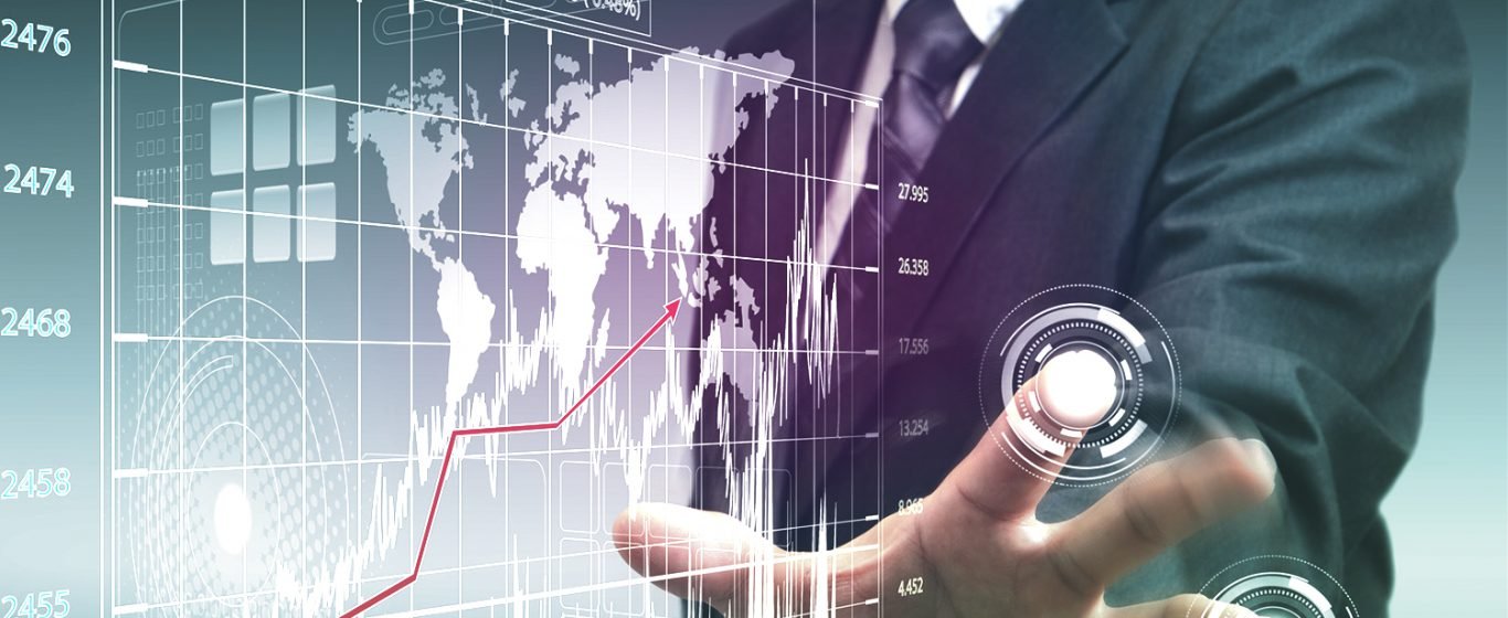 Businessman touches screen, analyzes graph