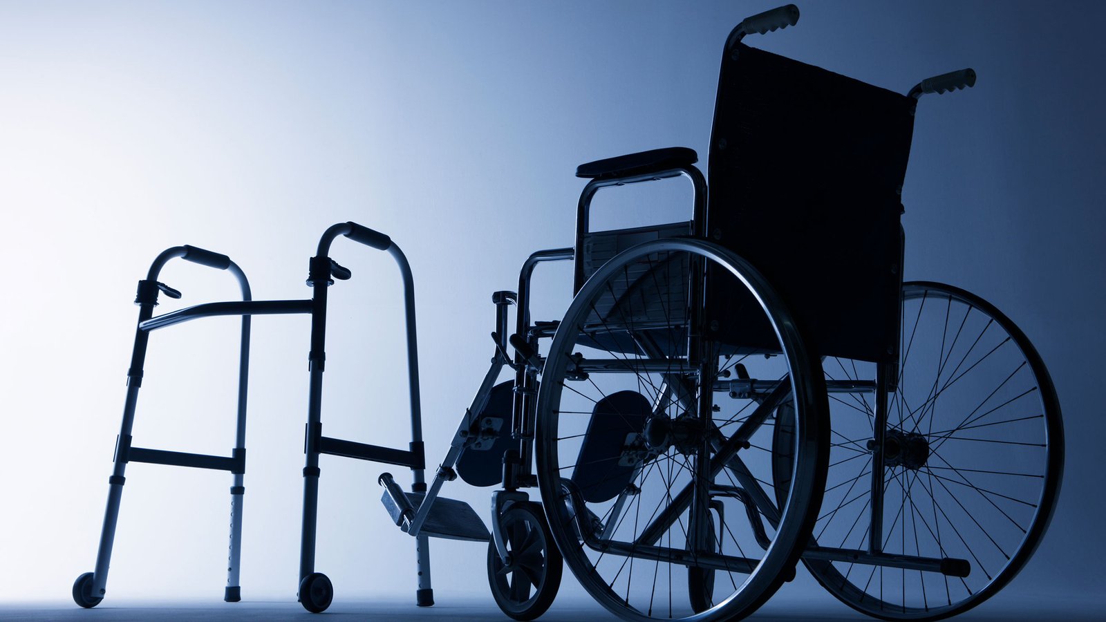 A silhouette of a wheelchair and a walker