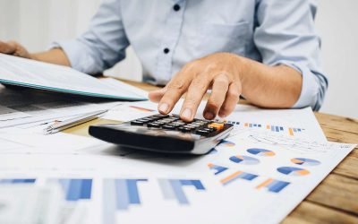 A businessman using a calculator to calculate financial data